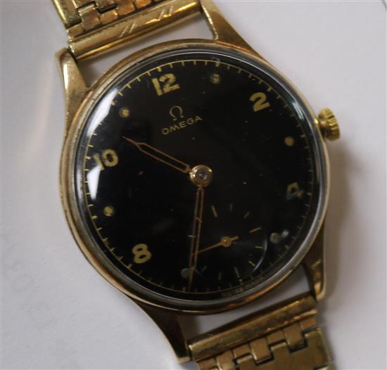 A gentlemans 1940s 9ct gold Omega wrist manual wind watch, with black Arabic dial on rolled gold bracelet.